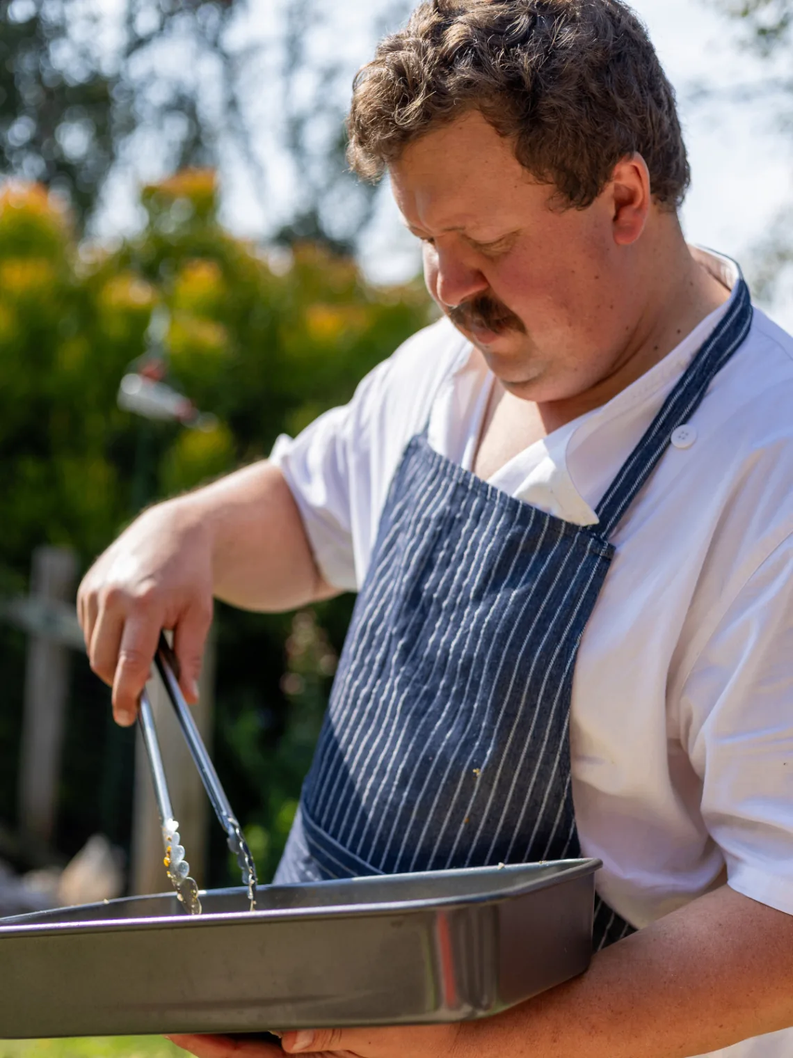 Chef preparing service trays for catering
