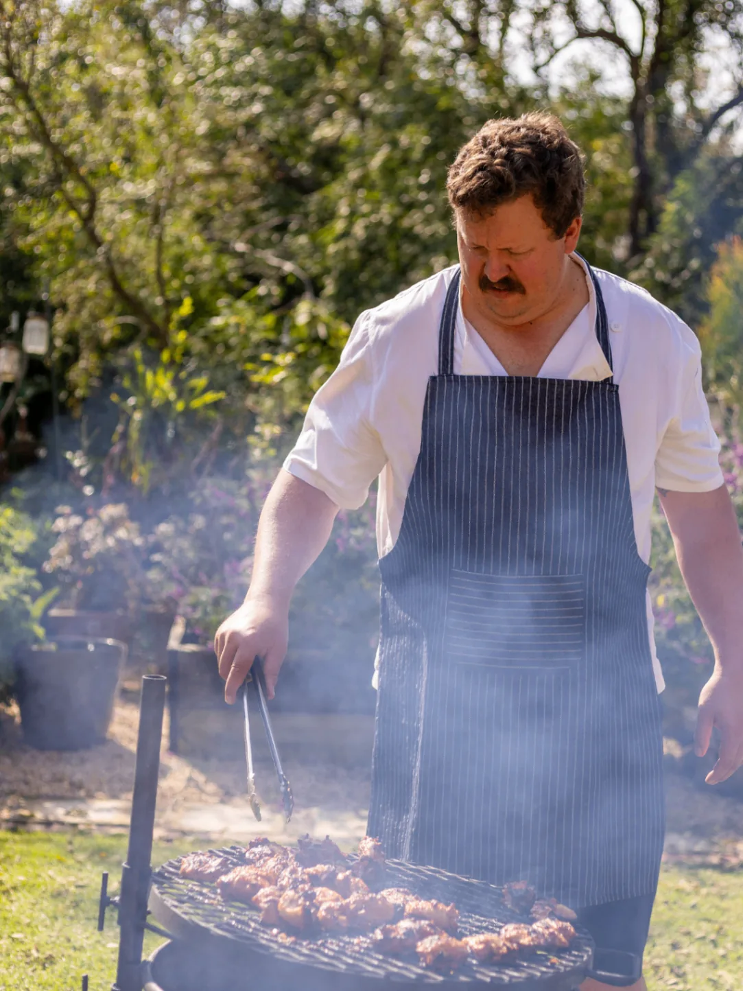 Chef grilling over an open fire